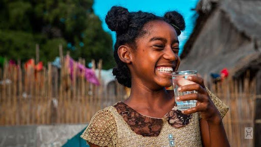 Smiling child drinking clean water
